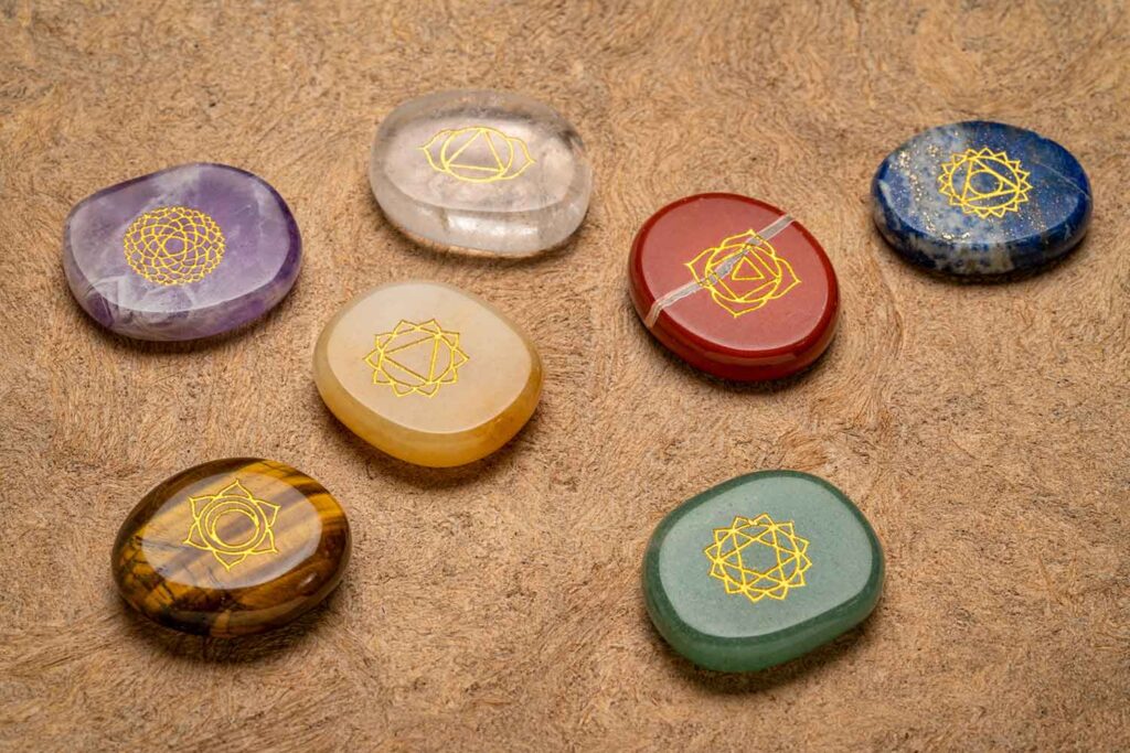 7 Chakra crystals with gold-painted chakra symbols